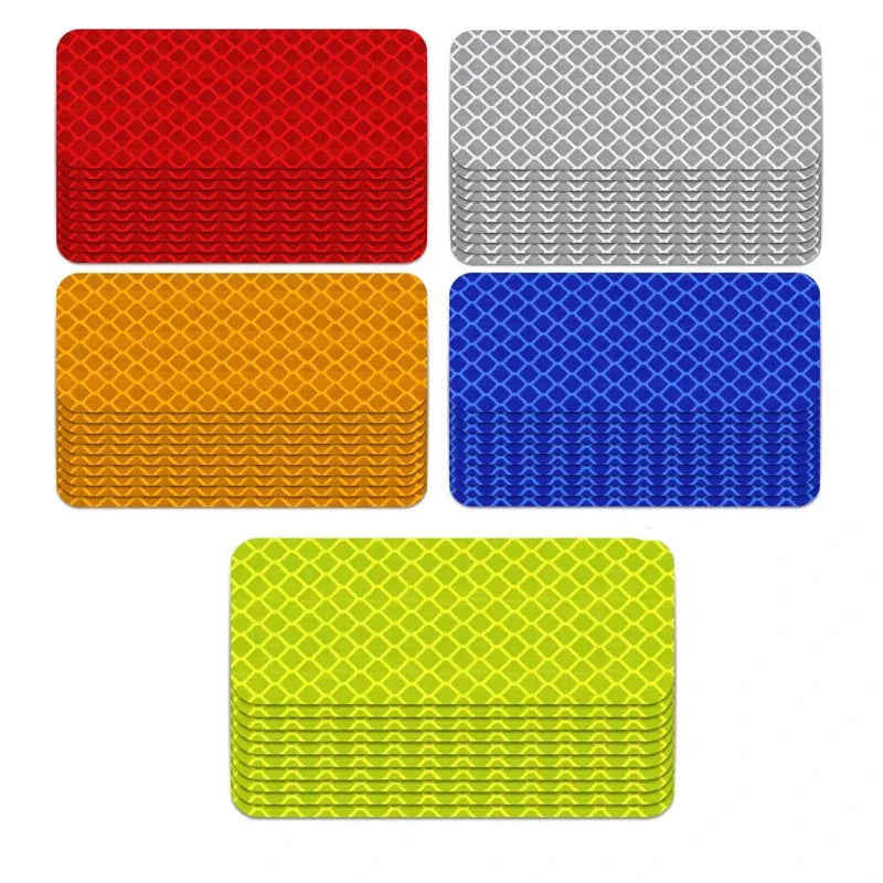 A collection of four square reflective strip stickers in red, gray, blue, and yellow.