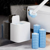 A white disposable toilet cleaning brush kit with an auto-open lid is shown next to a white toilet tank.
