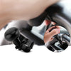 A close-up of a black steering wheel spinner knob and its mounting mechanism on a car steering wheel.