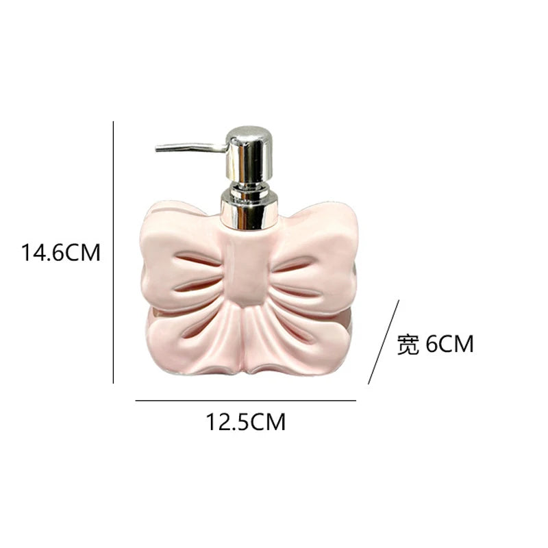 A pink ceramic pump dispenser with a silver pump mechanism for bathroom essentials.