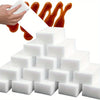 A stack of white multi-purpose magic cleaning sponges with orange liquid dripping from the top.