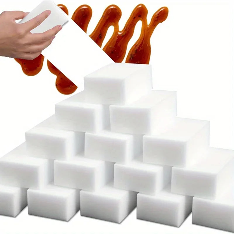 A stack of white multi-purpose magic cleaning sponges with orange liquid dripping from the top.