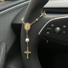 A gold-colored rosary necklace with a crucifix and pearl beads is displayed on a person's wrist.