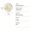 A white floral pacifier made of silicone with a flower shape and a ring design.