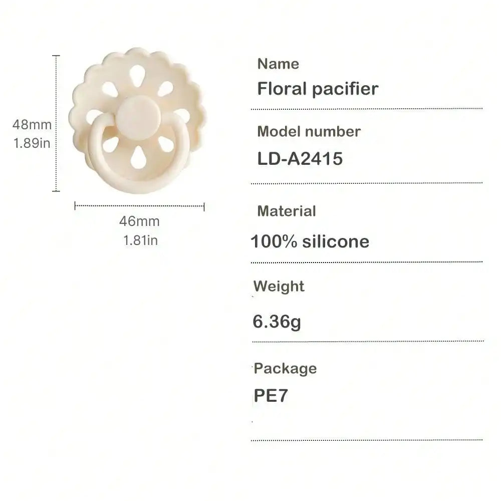 A white floral pacifier made of silicone with a flower shape and a ring design.