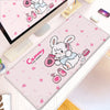 Pink kawaii cartoon desk mat featuring a white rabbit design for gaming