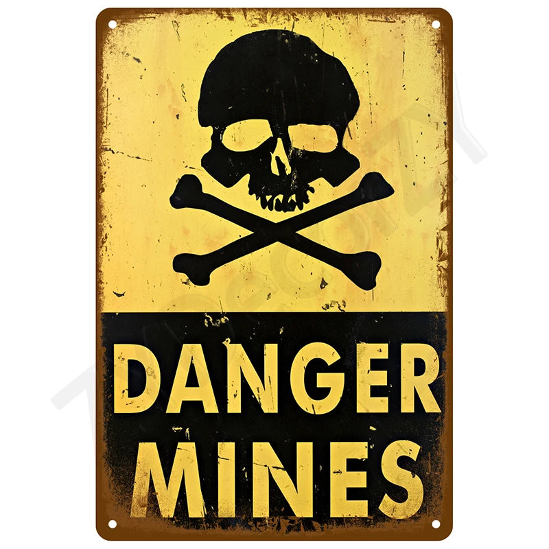 A vintage metal tin sign with a skull and crossbones symbol and the text DANGER MINES on a yellow background.