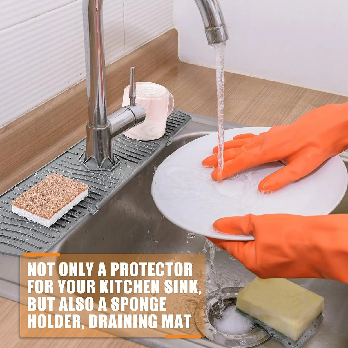Orange gloved hand pouring water from a silicone faucet mat into a kitchen sink.