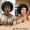 A man and a woman wearing black silk sleep caps for men and women.