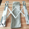 Foldable aluminum laptop stand with adjustable arms shown on a wooden surface.
