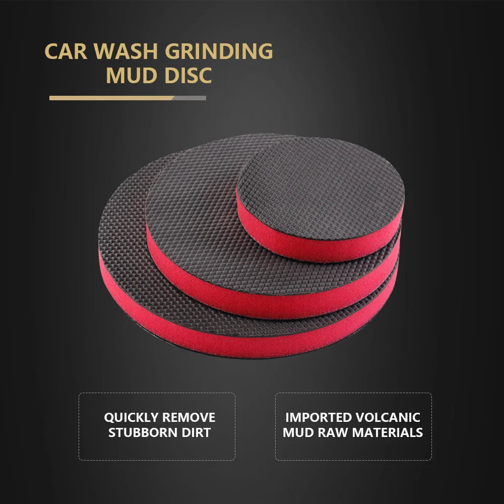 A pair of black and red car wash grinding mud discs for paint detailing.