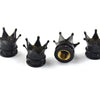 A set of four black universal crown valve caps for automotive or mechanical use.