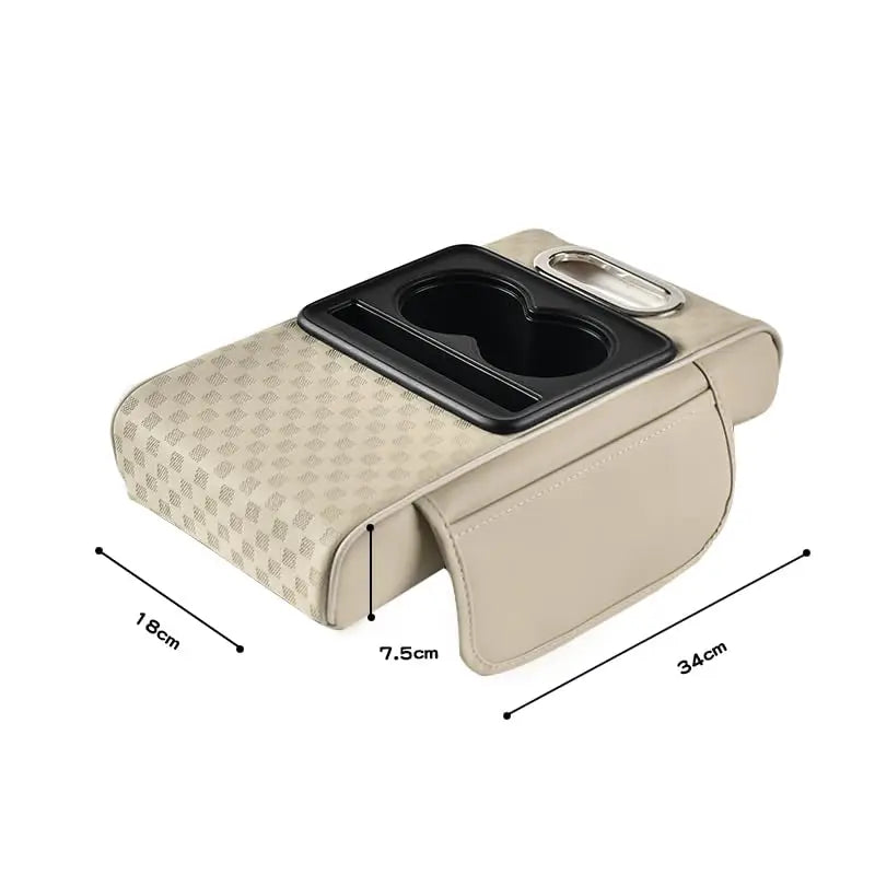A beige car armrest cushion with a black cupholder and storage compartment.