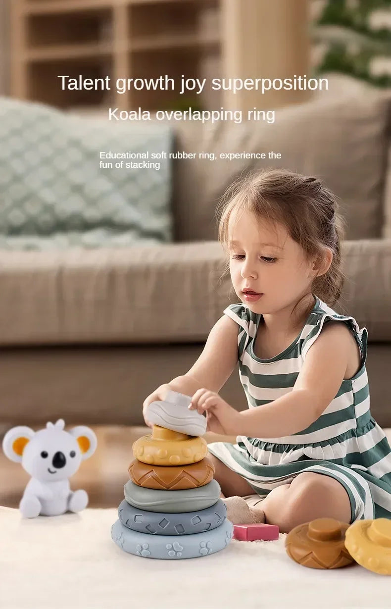 A young girl is stacking soft silicone rings and blocks for educational play on a table.