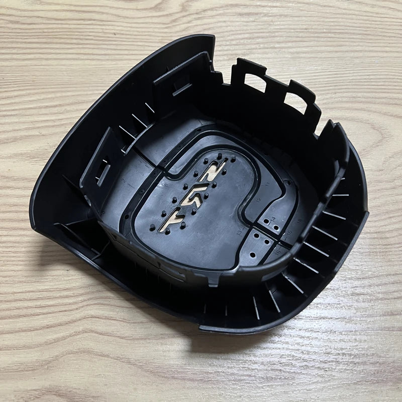 Black steering wheel cover with a silver SRT emblem