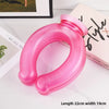 A pink U-shaped reusable neck wrap is shown on a white surface next to a book.