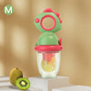 A rotating silicone baby fruit feeder with a dinosaur design, featuring green and pink parts and containing fruit.