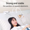 A woman is using a strong and stable flexible gooseneck phone holder for bedside viewing.