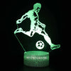 A glowing green silhouette of a person playing soccer is illuminated on a clear base.
