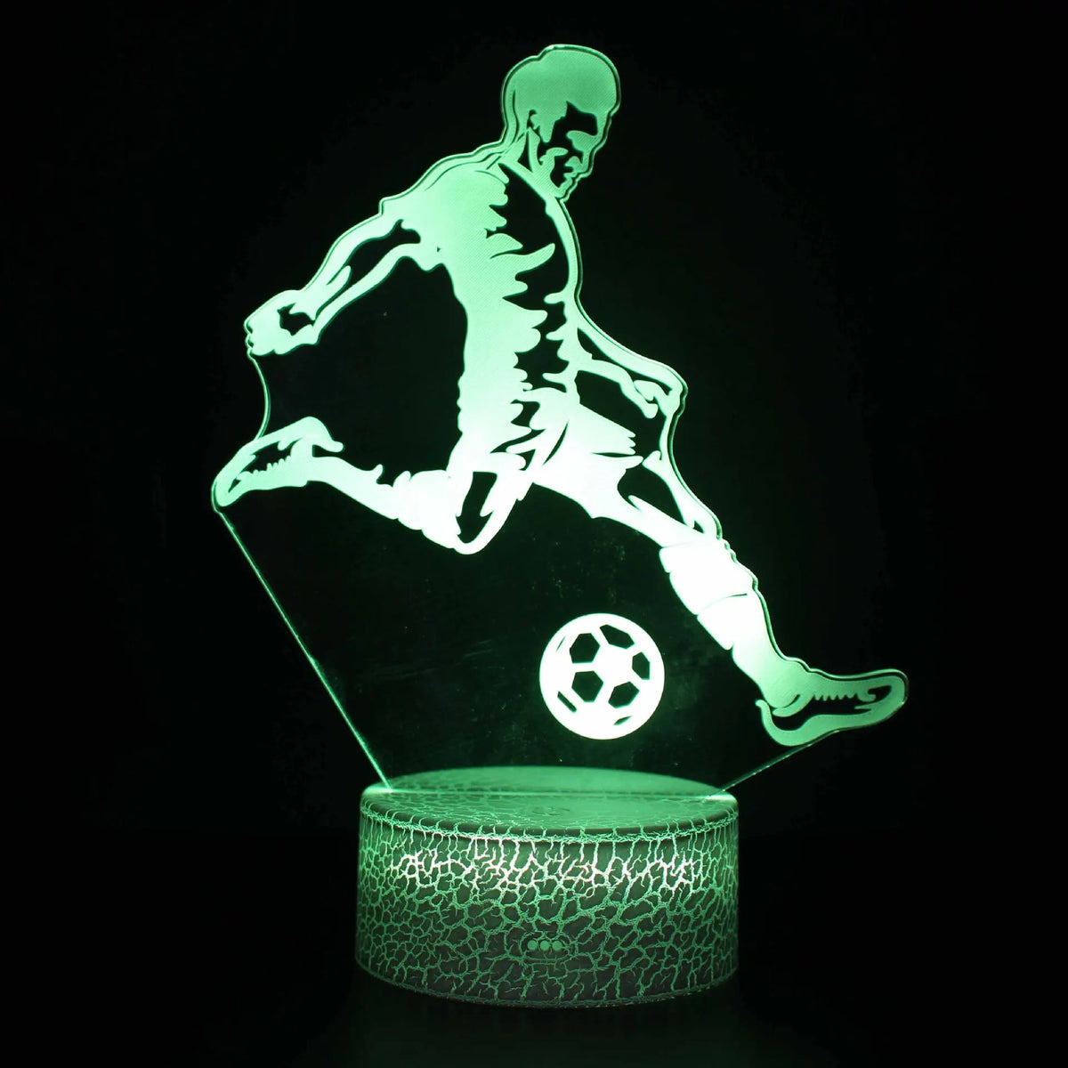A glowing green silhouette of a person playing soccer is illuminated on a clear base.