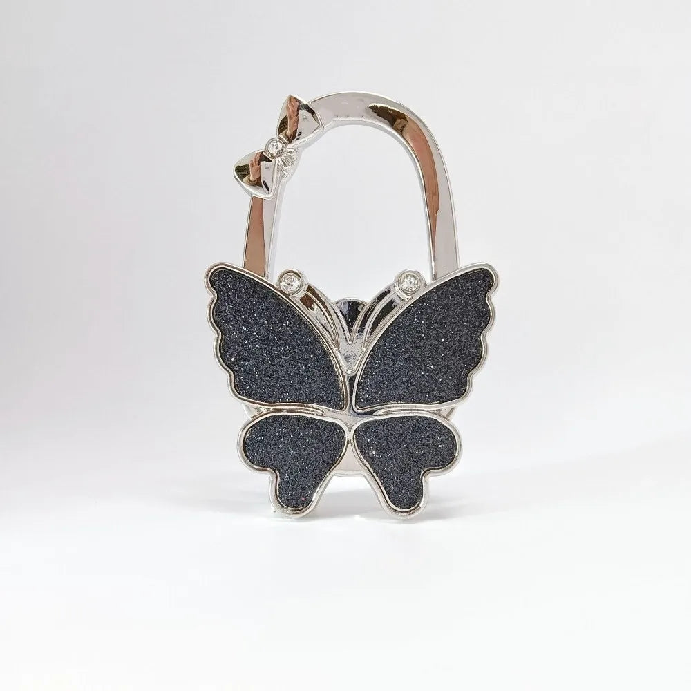 Silver foldable butterfly shaped handbag hook with sparkling details