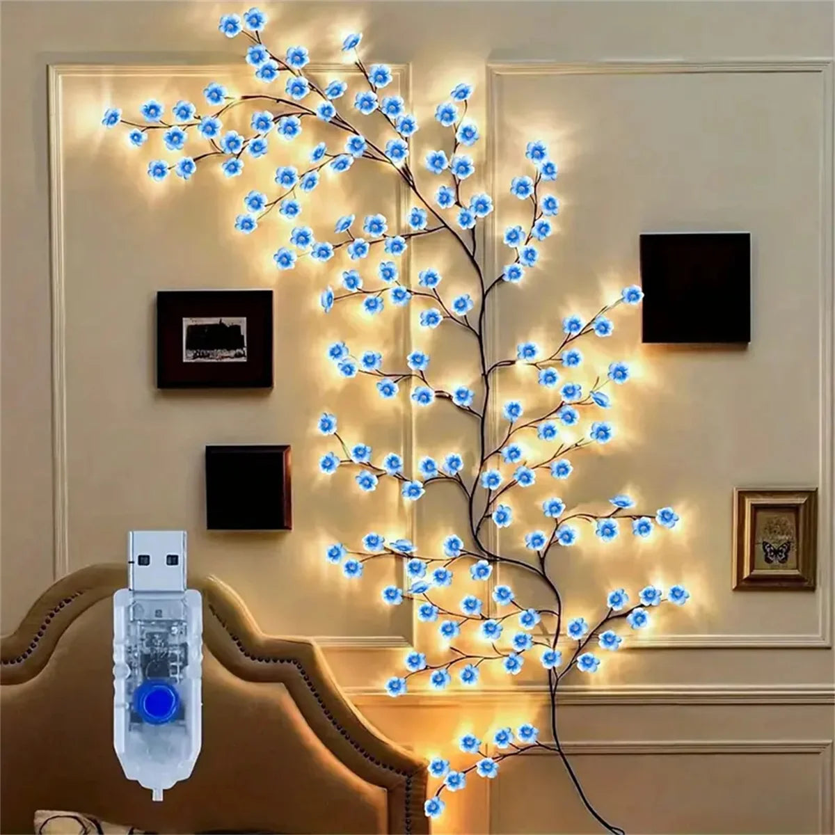 A decorative LED light string shaped like a cherry blossom tree illuminates a wooden chair.