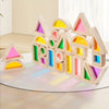 A colorful wooden building block structure shaped like houses and triangles for children's play