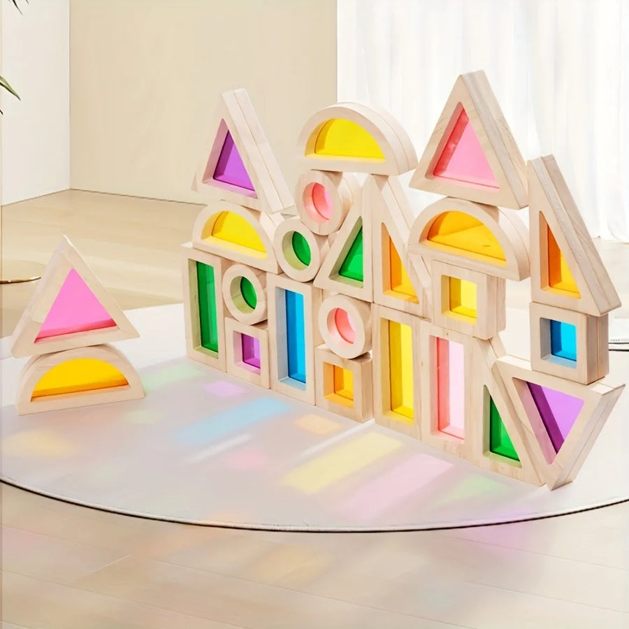 A colorful wooden building block structure shaped like houses and triangles for children's play