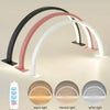 Three half-moon LED arc desk lamps in black, pink, and white with light color options shown.