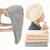A beige microfiber hair drying towel wrap is shown folded and several stacked towels are displayed.