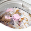 A close-up view of a washing machine lint and hair catcher filter bag filled with lint and hair.