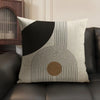 A beige linen cushion cover featuring a black geometric pattern of concentric lines and circles.