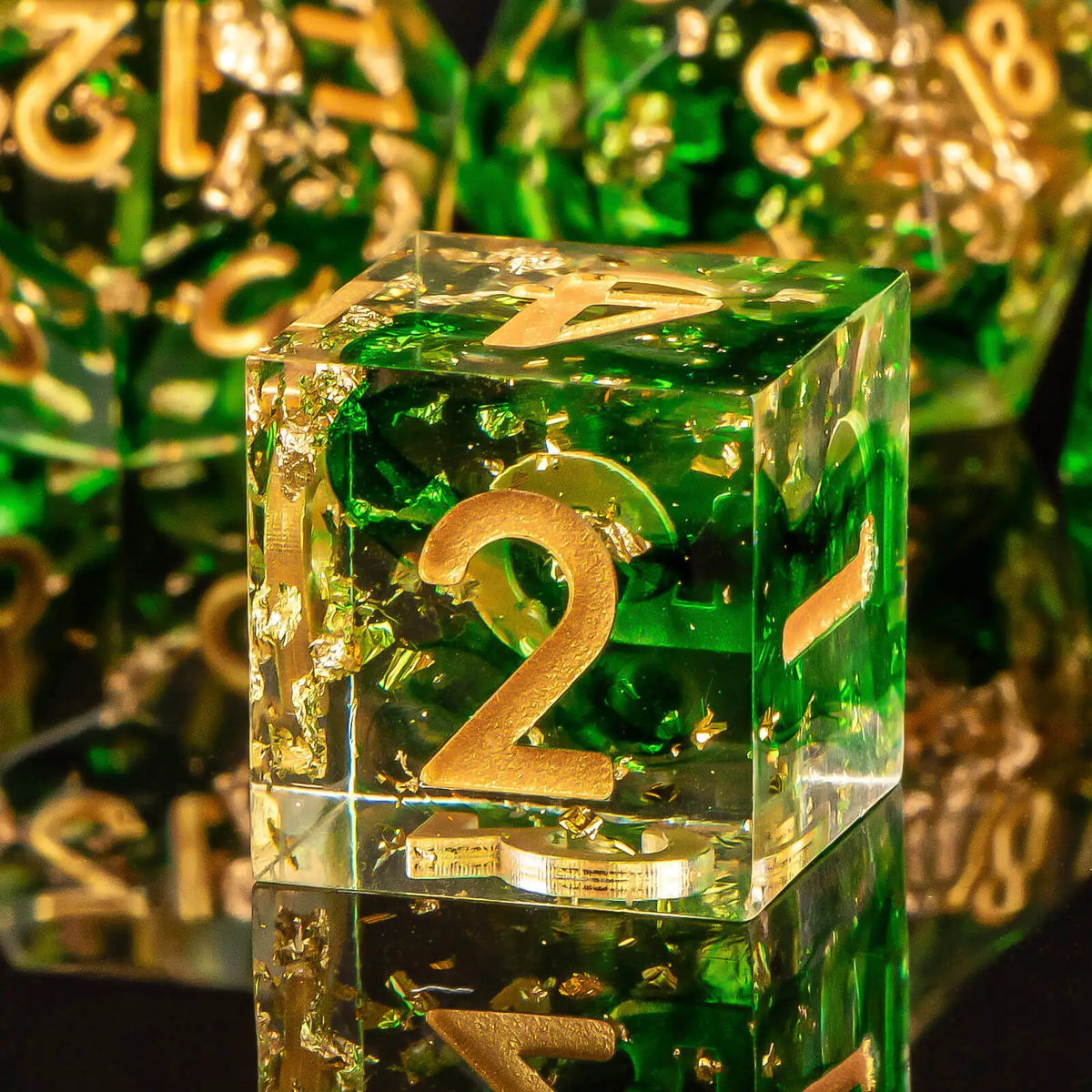 A clear green resin polyhedral dice set with gold accents, shown in a close-up view.