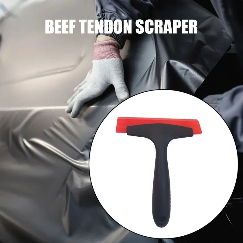 A hand wearing a glove is using a beef tendon scraper tool on a dark surface.