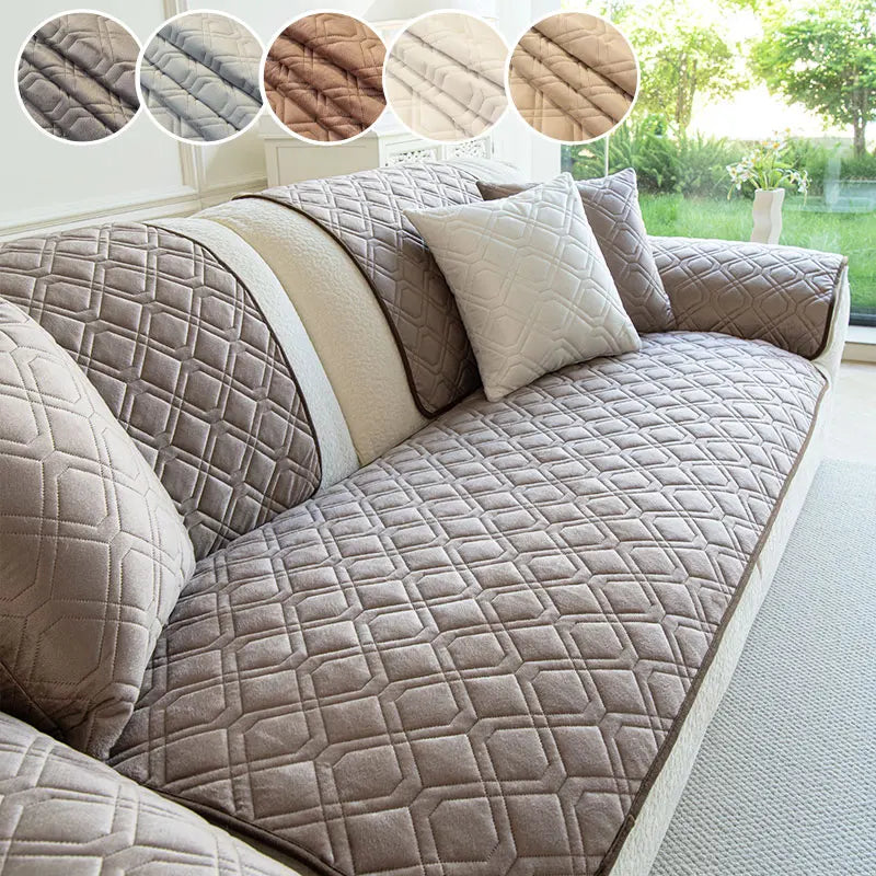 A beige anti-slip sofa cover with a quilted geometric pattern shown on a sectional sofa.