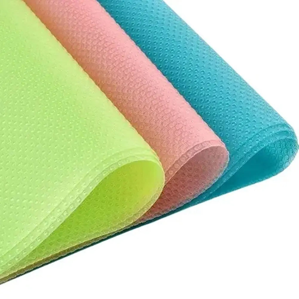 Rolls of colorful waterproof refrigerator liner mats in lime green, peach, and turquoise.