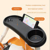 A black 3-in-1 stroller snack tray with a food area, beverage area, and phone slot is shown in an orange carrier.