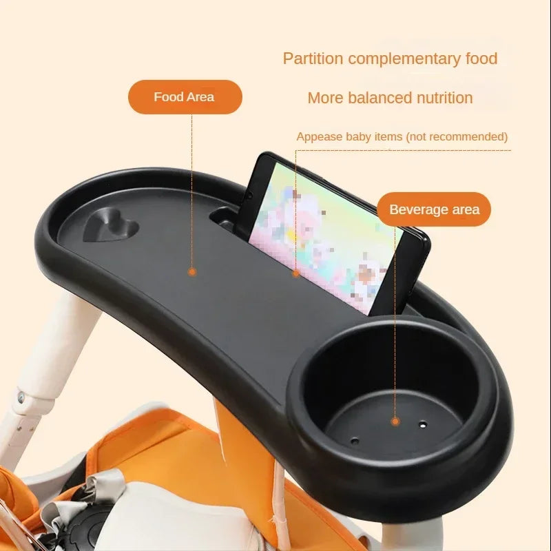A black 3-in-1 stroller snack tray with a food area, beverage area, and phone slot is shown in an orange carrier.