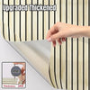 A hand is shown peeling off a section of upgraded thickened wood grain wallpaper roll with vertical stripes.