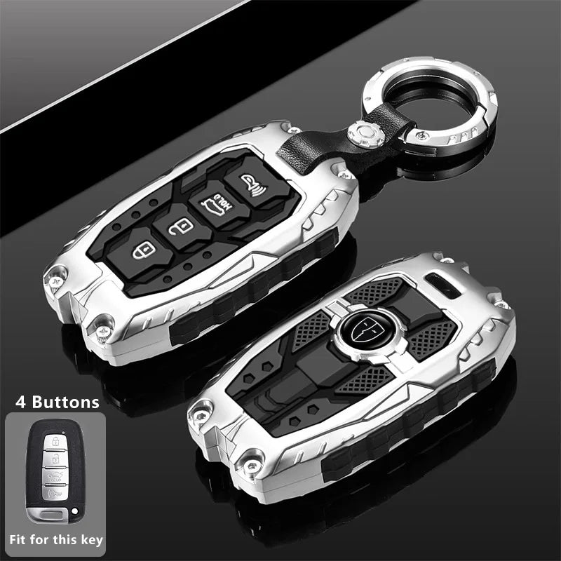 Silver protective cover for a key fob with four buttons shown against a dark background.