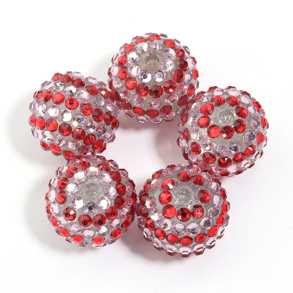 A set of five round resin rhinestone beads with a two-tone red and clear striped design.