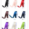 Rolls of double face satin ribbon in various colors including black, pink, red, brown, blue, and purple.