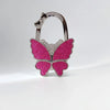 Silver butterfly shaped hook for a foldable handbag or purse.