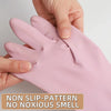 A hand is holding a pink reusable non-slip rubber dishwashing glove, showing the texture and fit.