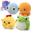 A set of crocheted animal figures including a blue, orange, yellow, and green creature.