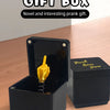 A black surprise gift box with an open lid revealing a golden middle finger hand.