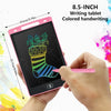 A hand holds a pink 8.5-inch LCD writing tablet with a stylus, demonstrating colored handwriting on the screen.