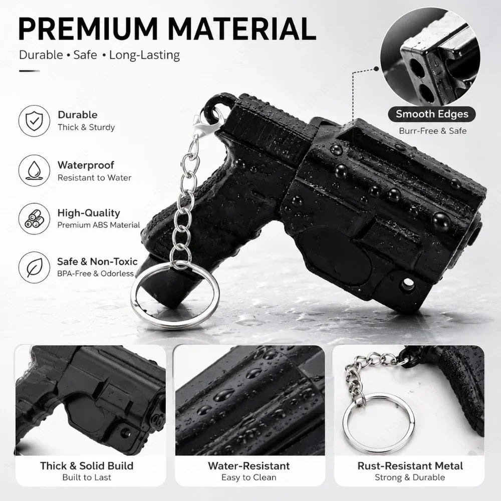Black 3D printed mini pistol-shaped keychain set with a silver chain and various features highlighted.