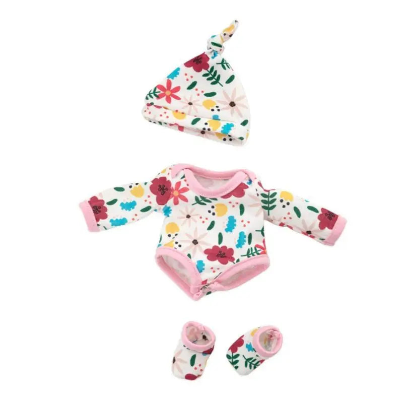 A floral print jumpsuit outfit for a baby doll featuring white, pink, and green patterns.