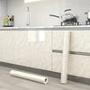 Pearlescent pink marble peel and stick wallpaper applied to kitchen cabinets